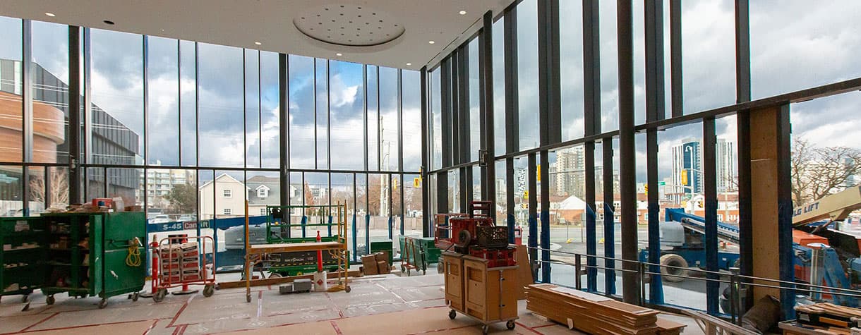 Room with large glass windows and construction equipment