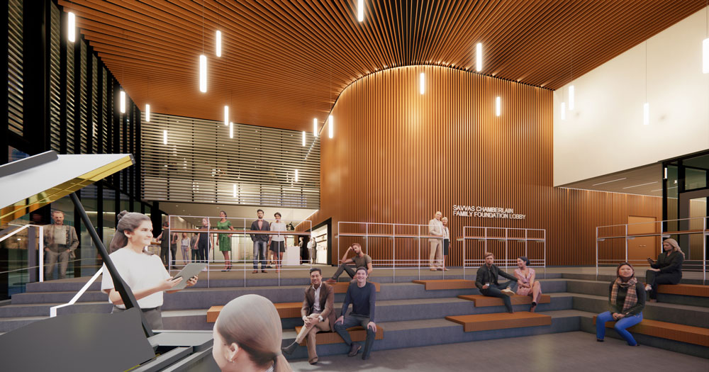 Interior view; students singing next to piano with audience.