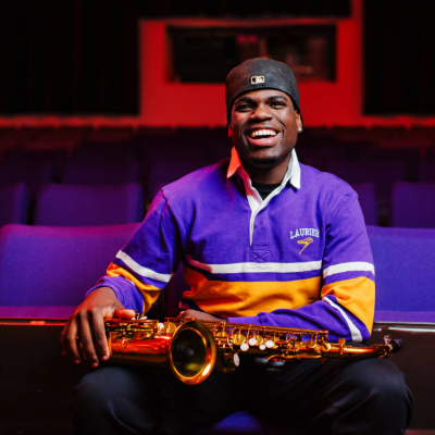 music student sitting with his saxophonempatheater