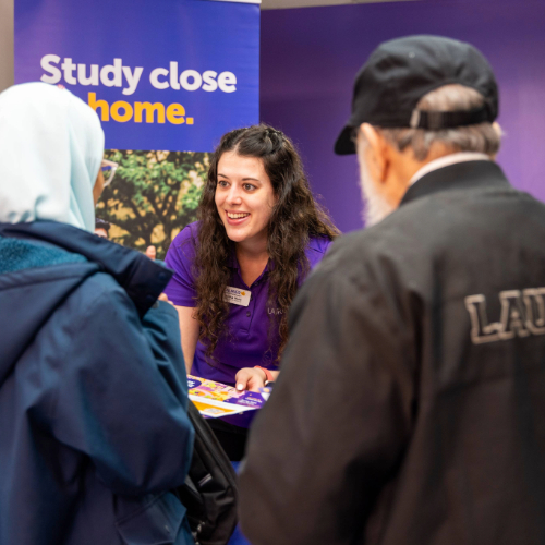 Staff speaking to milton open house attendees