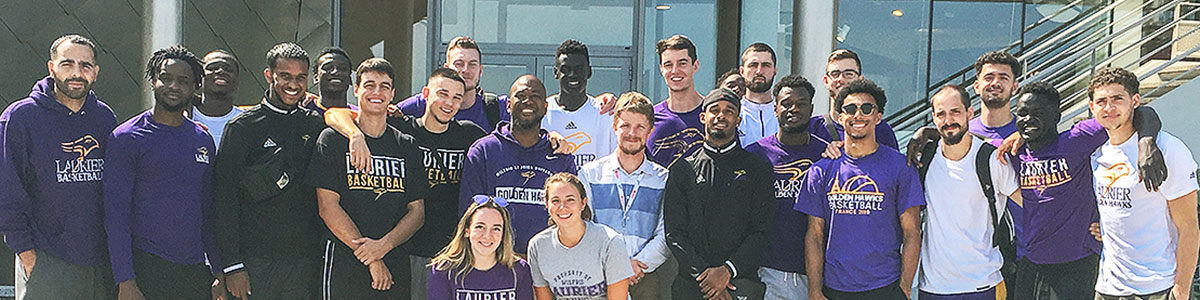 Laurier's Men's Basketball Team group shot outside Juno Beach museum in Normandy, France
