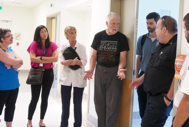 Milner with medical staff in a hallway.