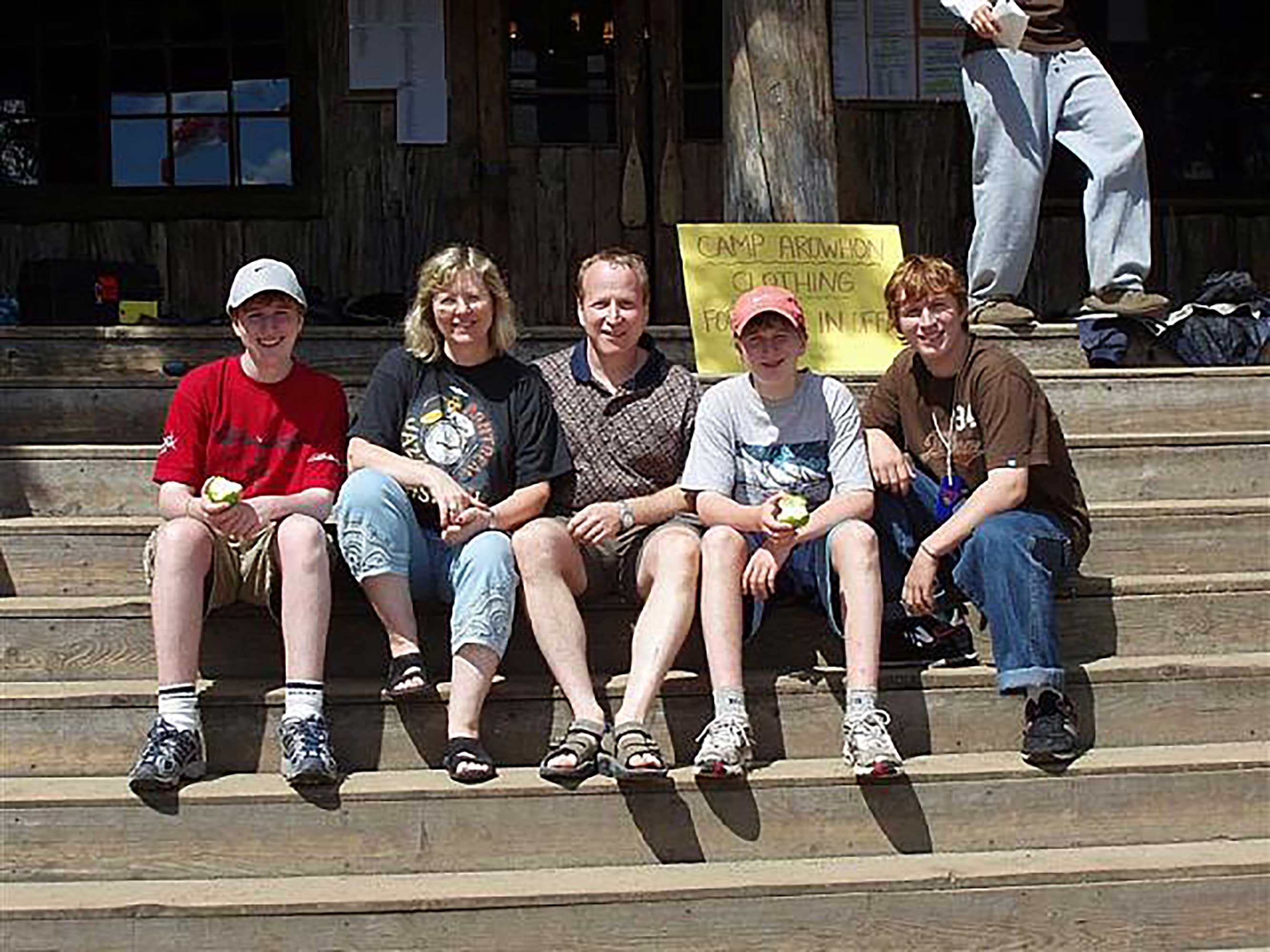 The Levene Family sits on the steps at Camp Arowhon