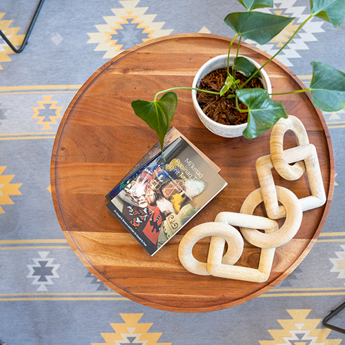 wooden puzzle and books on a side table at the Brantford Indigenous student centre