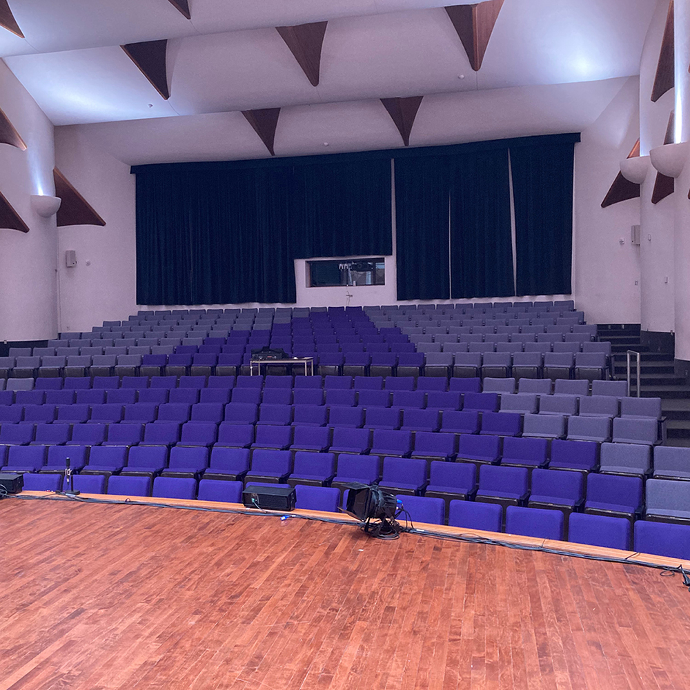 View from the stage of the Maureen Forrester Recital Hall, showing the refurbished seats in purple and grey.