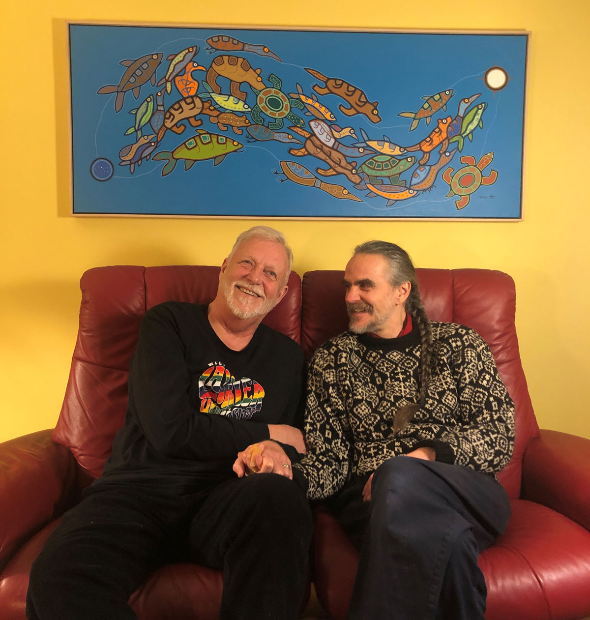 Guy Milner and Roger Helfrick with the art they donated to Laurier